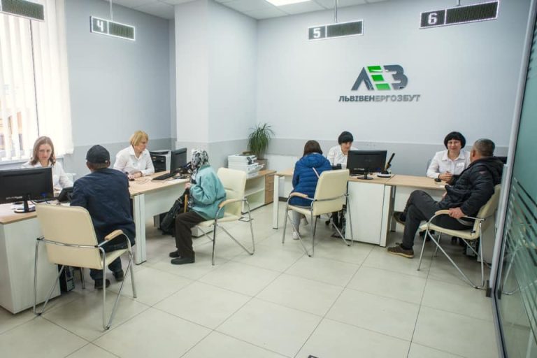 Lvivenergozbut customer service hall overview with counter displays and the LEZ logo