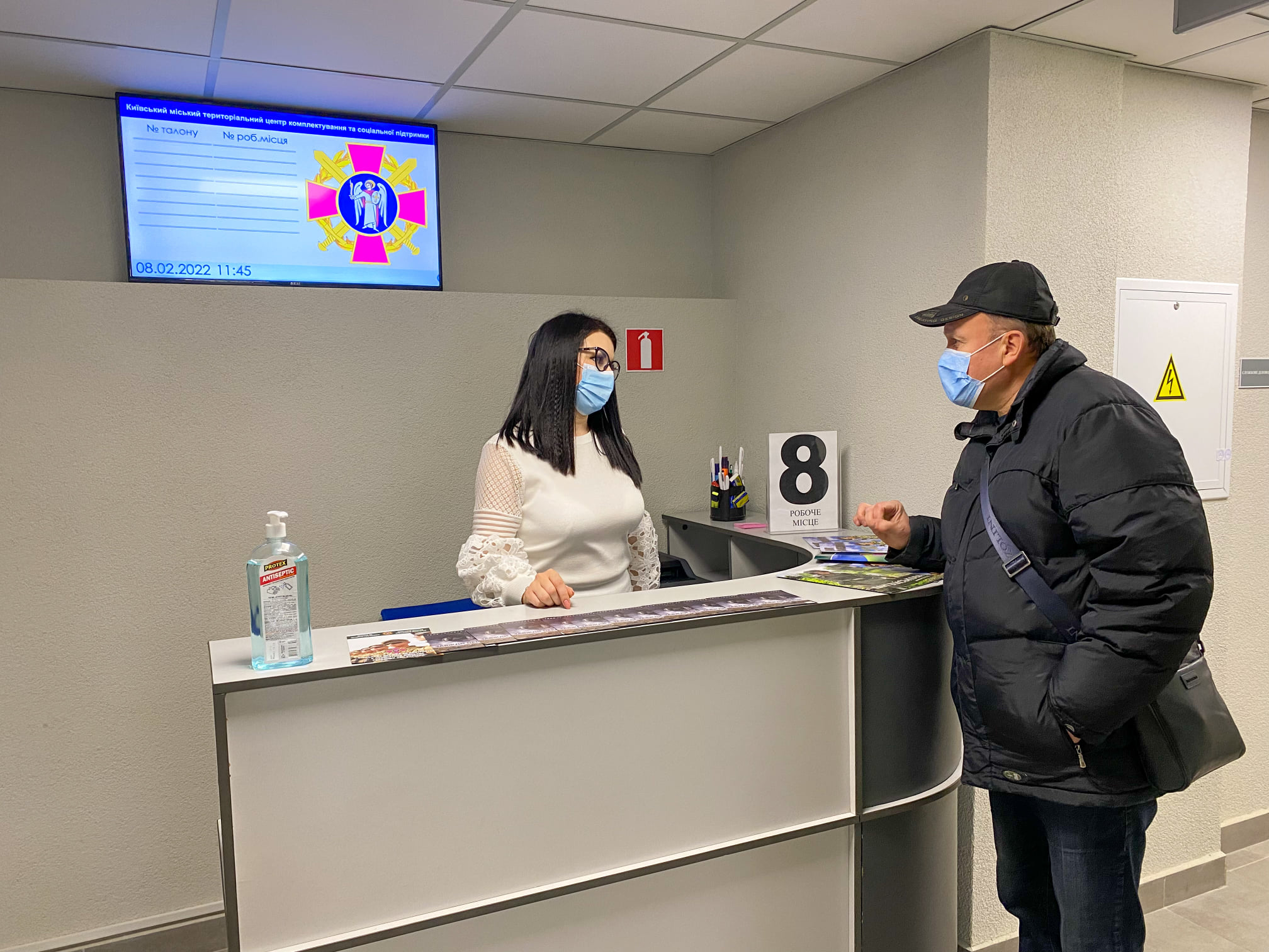 Officials inspecting the QSolutions queue management system