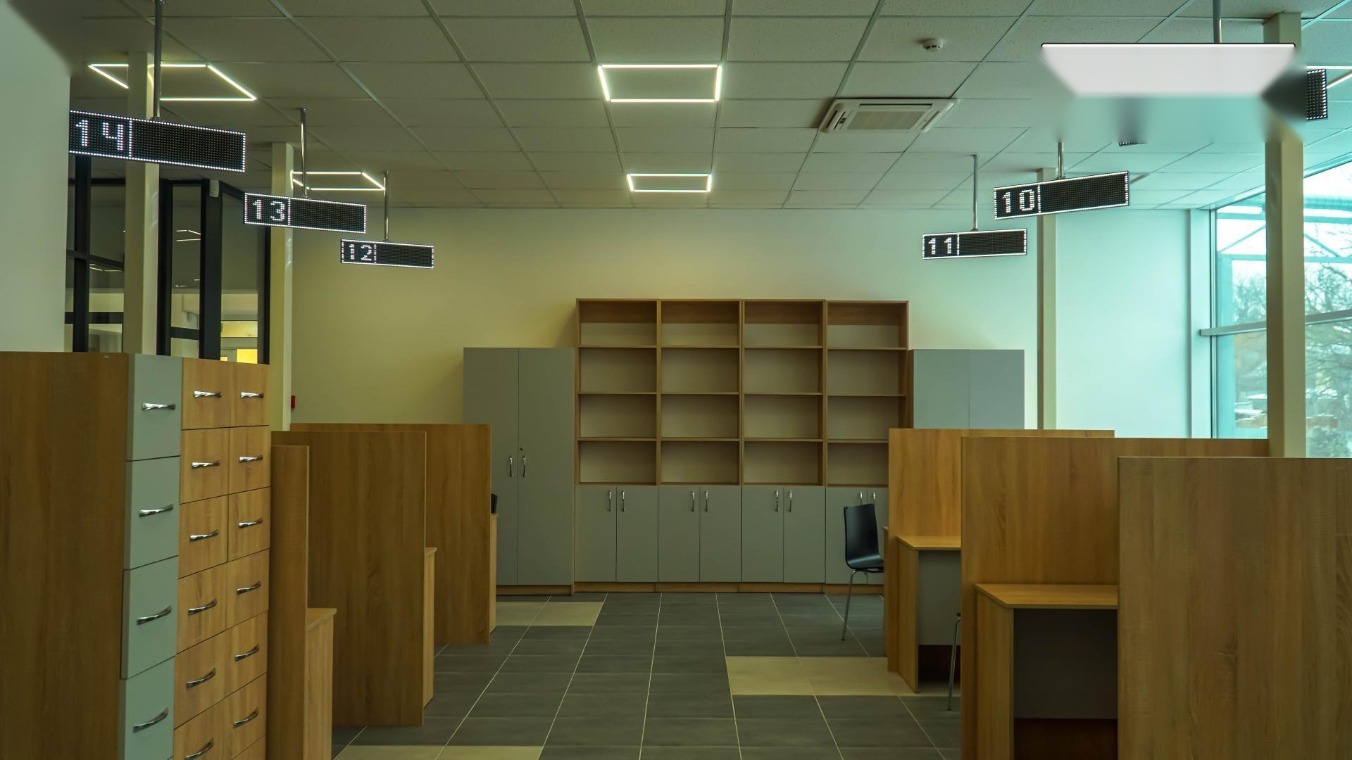Service area of the Drohobych Diia.Center showing five RGB Matrix PRO LED counter indicators numbered 10 through 14 over individual workstations