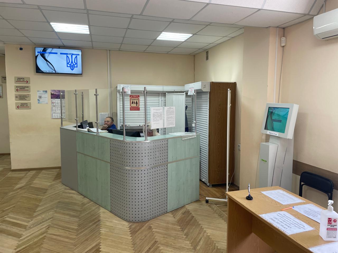 2nd-floor Prophylactic Examinations reception with QSolutions main display and self-service kiosk
