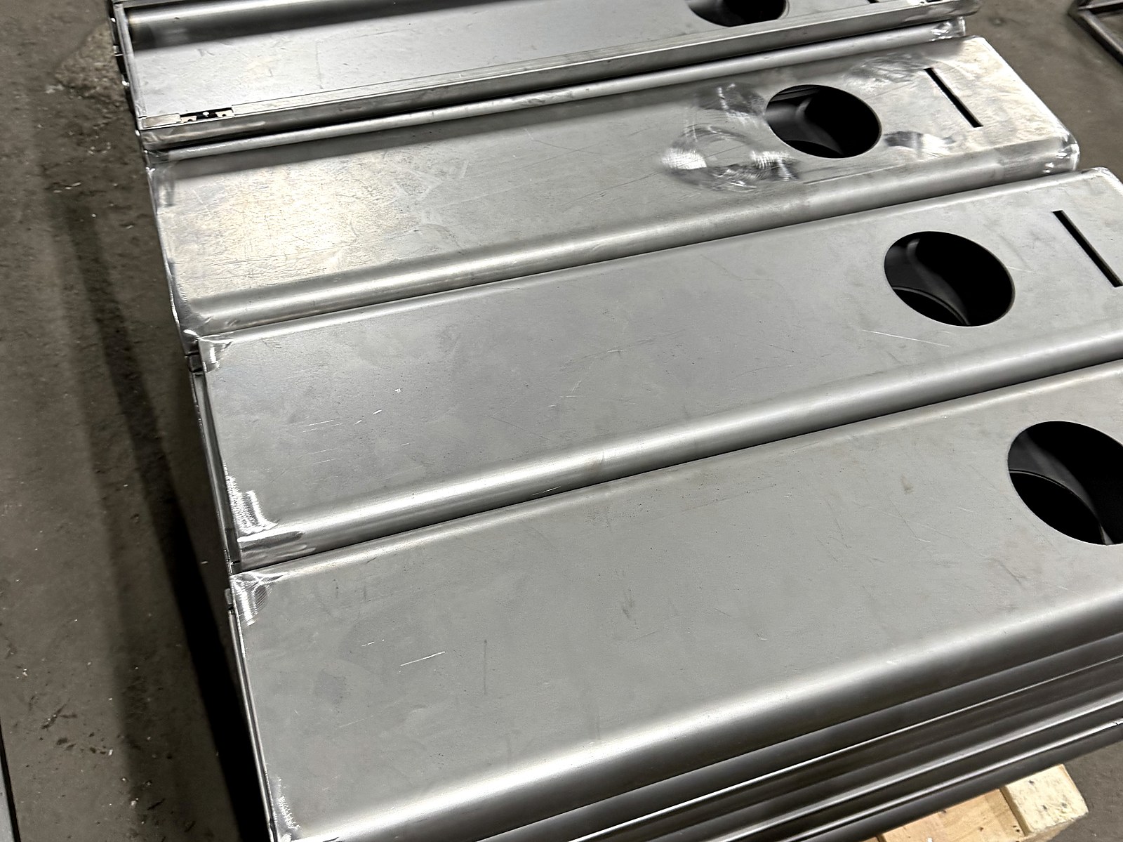 Raw sheet-metal panels stacked on a pallet after primary processing