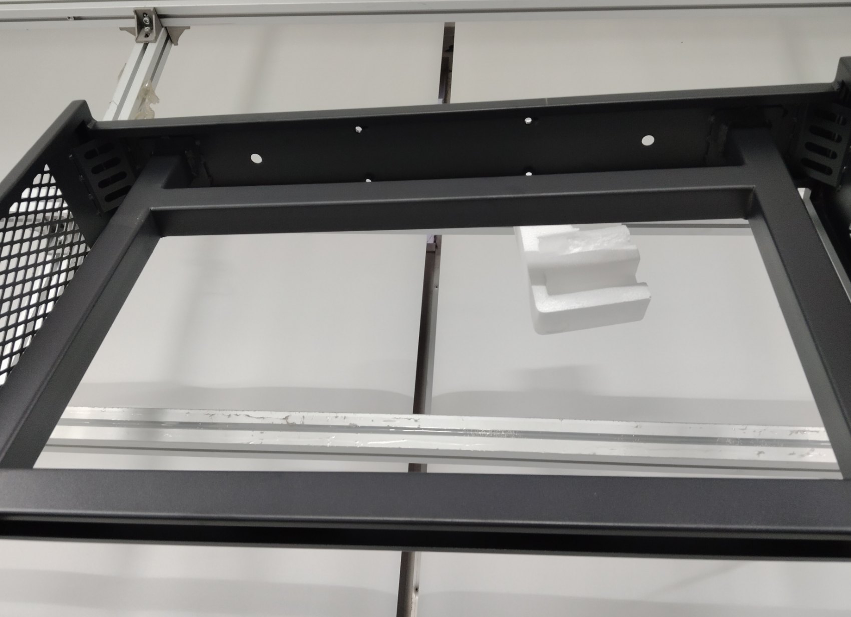 Welded enclosure section of the 65″ Slim with a ventilation panel and mounting holes