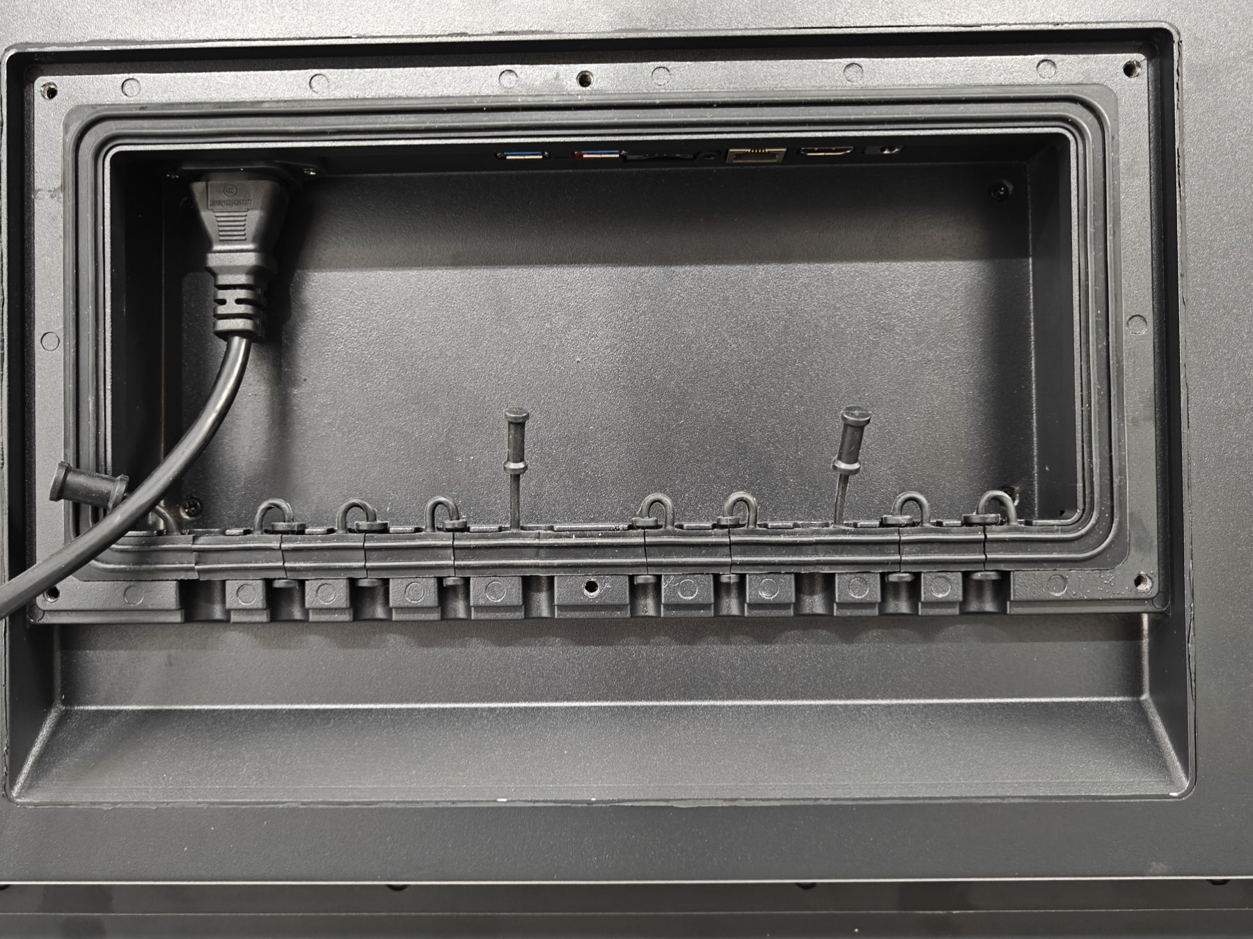 Power-input recess and cable comb